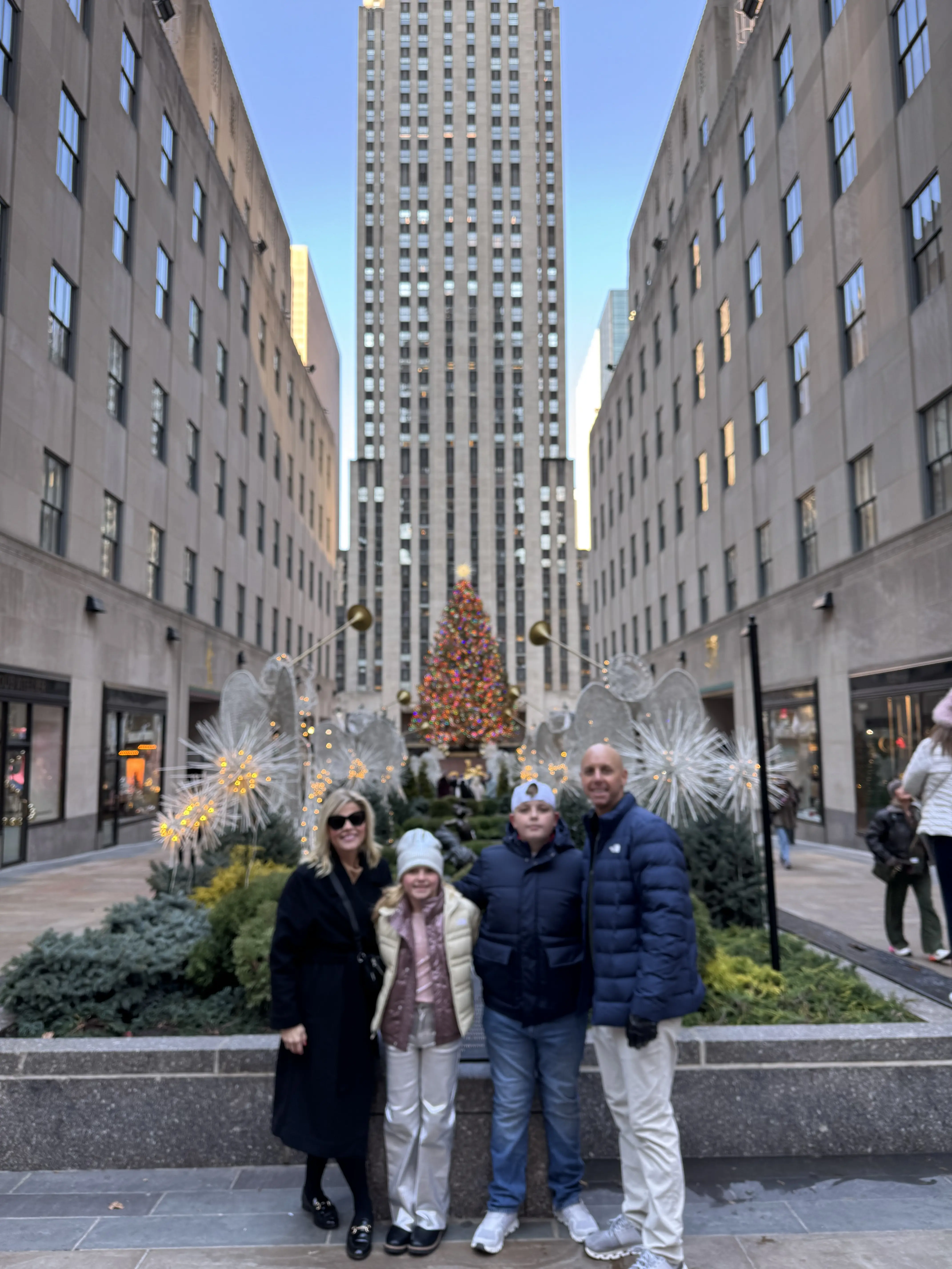 A smiling family on a tour in NYC.