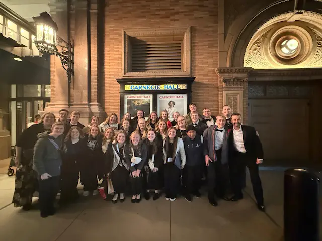 Southwest Christian Schools choir group posed in front of Carnegie Hall.